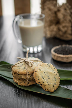 cookies with sesame seeds and glass of milk, homemade sweet cookies