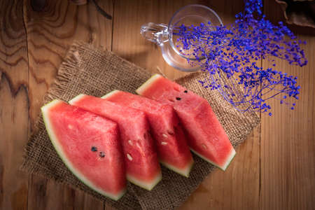 Fresh sliced watermelon wooden backgroundの写真素材