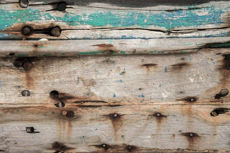 Old wooden boat wall background, Close up of wall with layers of chipping paint flakesの写真素材
