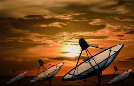 Big black Satellite Dish on sunset backgroundの写真素材