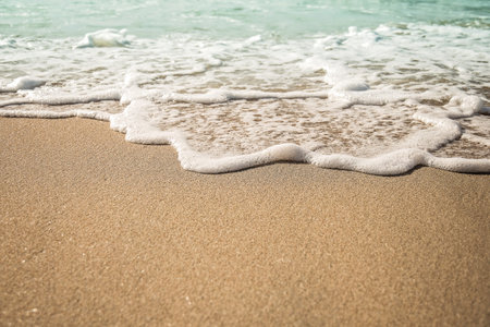 Background soft wave of Sea with foam on sandy beach, copy space.の写真素材