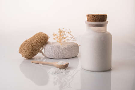 Spa arrangement with sea salt and bathing brush on white backgroundの写真素材