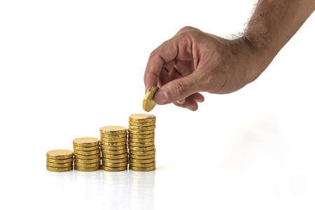 Man's hand put money coins to stack of coins, Business Growth concept.の写真素材