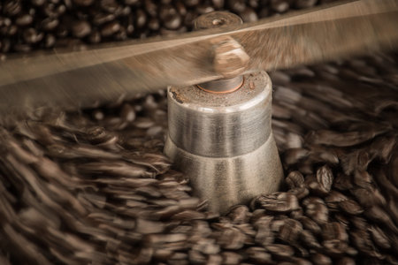Coffee beans during the roasting process, moving paddle of the screening hopper cooling the coffee...