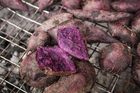 Fresh sweet potato with root at farmer market as a food backgroundの写真素材