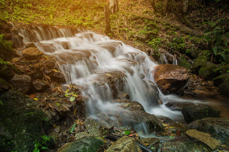 soft water of the stream in the natural park, Beautiful waterfall in rain forest ( Maekampong Waterfall, Thailand)の写真素材