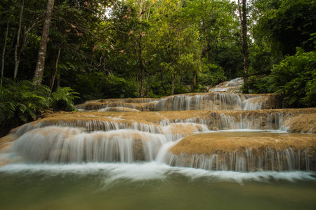 soft water of the stream in the natural park, Beautiful waterfall in rain forest ( Maekae Waterfall, Thailand)の写真素材