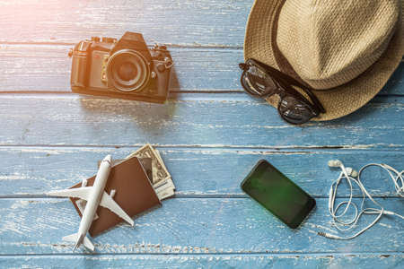 Tourist travel planning concept on wood with passport, airplane, camera,hat and sunglasses. Travel Conceptの写真素材