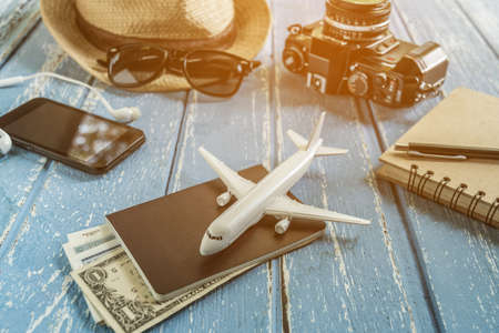 Tourist travel planning concept on wood with passport, airplane, camera,hat and sunglasses. Travel Conceptの写真素材