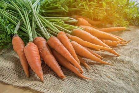 Fresh and sweet carrot on wooden table, Healthy food.の写真素材