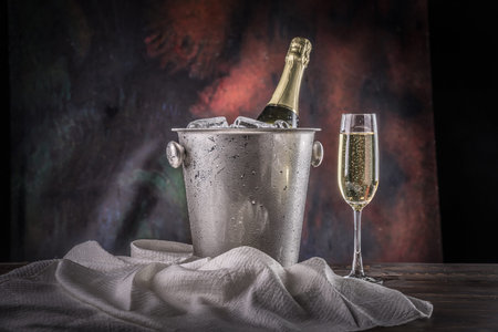 Glass of champagne with bottle in metal container,  still life.の写真素材
