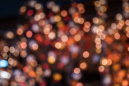 Lights blurred bokeh background from christmas night party for your design, vintage or retro color...