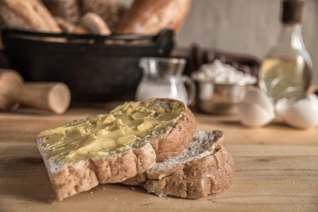 Male baker prepares bread. Male baker sprinkle the dough with flour. Making bread. Top view. Rustic...