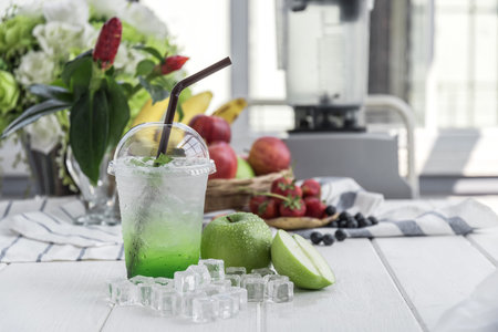 Green apple italian soda arranged on wood table,