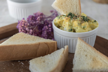 toasts with hard boiled eggs and mustard, preparing healthy breakfast,