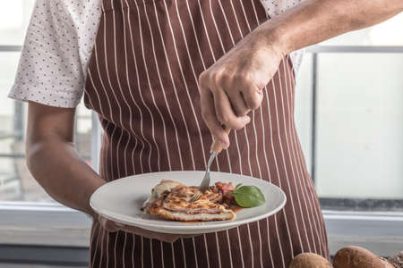 cooking healthy diet food in the home kitchen, Healthy Chicken parmesan with spices in baking dish on tableの写真素材