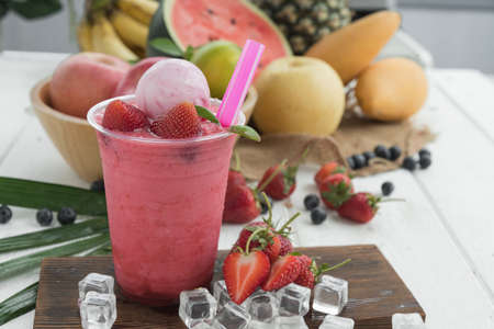 Summer refreshing healthy drink , strawberry smoothie or fresh with mint on fuirts backgroundの写真素材