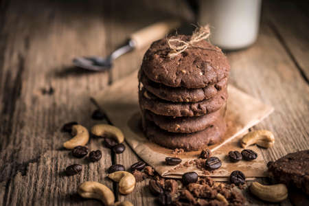 freshly baked coffee beans with cashew nuts cookies on rustic wooden tableの写真素材