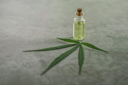 cannabis essential oil container with cannabis leaves and cannabis seedsの写真素材
