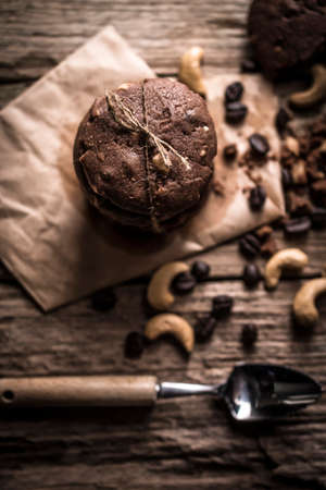freshly baked coffee beans with cashew nuts cookies on rustic wooden tableの写真素材