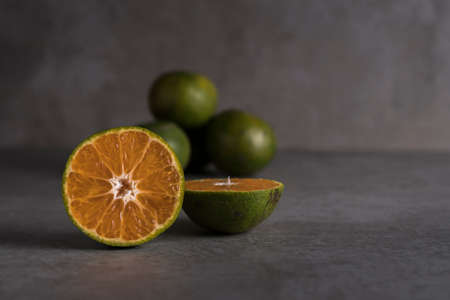 Fresh orange fruits and juice on stone table with copy spaceの写真素材