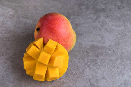 mango on a dark background, tinting selective focus on the mangos slicesの写真素材