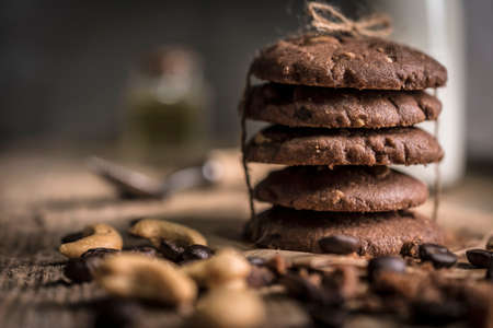 freshly baked coffee beans with cashew nuts cookies on rustic wooden tableの写真素材