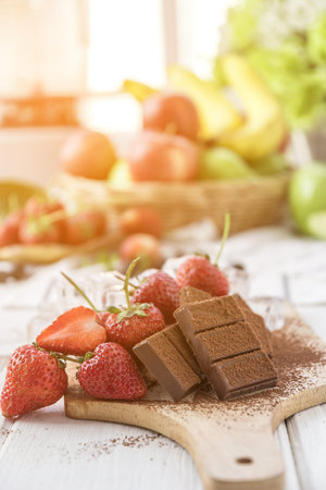 Chocolate with fresh strawberry, blueberry on wooden tableの写真素材