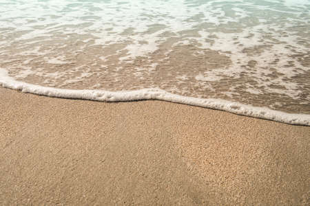 Background soft wave of Sea with foam on sandy beach, copy space.の写真素材