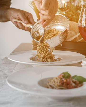 Close up low angle view of a plate of spaghetti topped with delicious bolognaise sauce and basilの写真素材