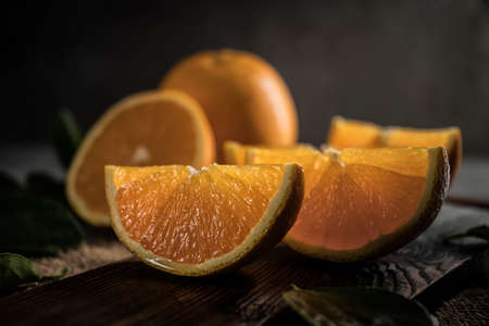 Beautiful, fresh orange on the dark background. Healthy sweet food concept. Mock up for fruits offers as advertising or web background, or other ideas. Empty place for text or logo.の写真素材