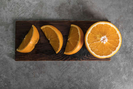 Beautiful, fresh orange on the dark background. Healthy sweet food concept. Mock up for fruits offers as advertising or web background, or other ideas.の写真素材