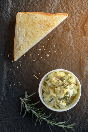 toasts with hard boiled eggs and mustard, preparing healthy breakfast,
