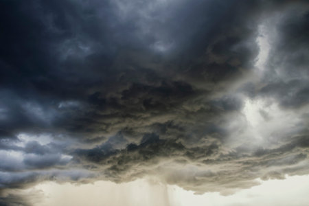 Light in the Dark and Dramatic Storm Clouds background, Black cumulus clouds before the beginning of...