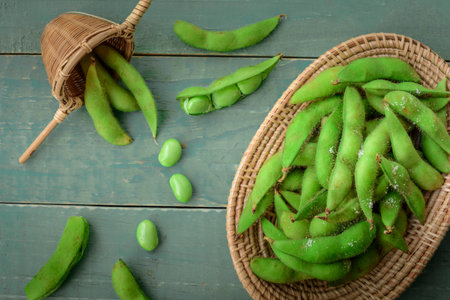 Green Japanese Soybean in wooden bowl on table wood, Fresh steamed edamame sprinkled with sea salt