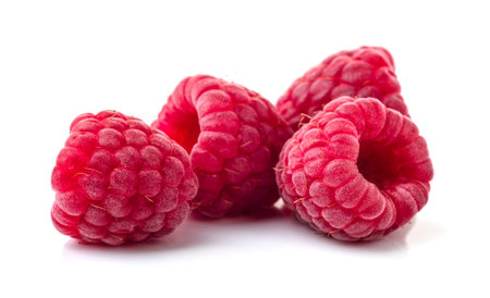 Raspberries in closeup islated on white background.