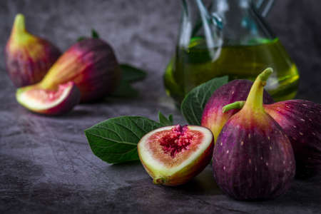 Fresh ripe figs on dark table. Healthy mediterranean fig fruit. Fresh figs on black background. Beautiful blue violet figs with empty copyspace close upの写真素材