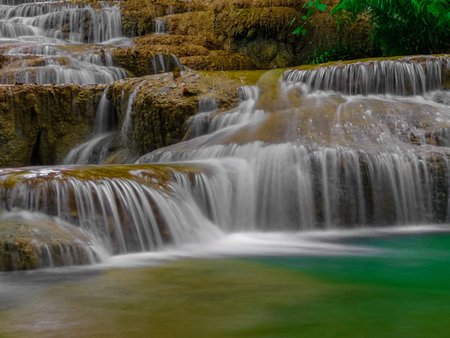 soft water of the stream in the natural park, Beautiful waterfall in rain forest ( Maekae Waterfall, Thailand).の写真素材