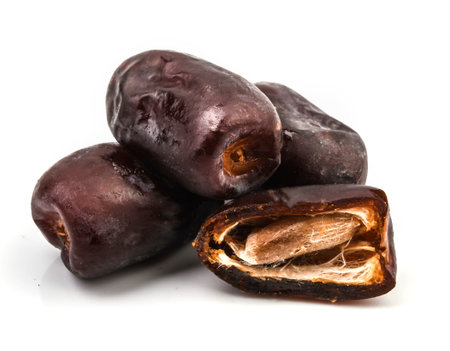 Dried split date (fruit of palm Phoenix dactylifera). Infinite depth of field, isolate on white...