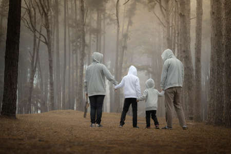 Young family with children having fun in nature, father, mother and children.の写真素材