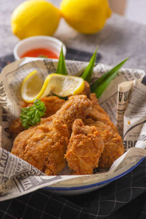 Fried chicken legs with lemon and parsley.の写真素材