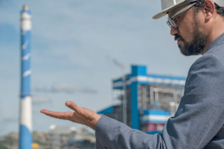 Businessmen at power plant background, safety helmet for safety concept and power plant project site...