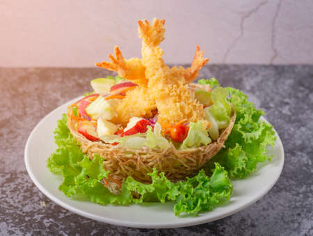Tempura Jumbo Shrimps with salad and salsa dip on white plate.の写真素材