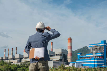Businessmen at power plant background, safety helmet for safety concept and power plant project site background.の写真素材