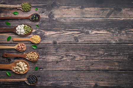 Mix of nuts in wooden spoon, Nuts mix on a wooden background