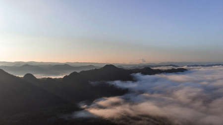 Landscape of Morning Mist with Mountain Layer at  north of Thailand. Aerial View. Flying over the high mountains in beautiful clouds. Aerial camera shot.の写真素材