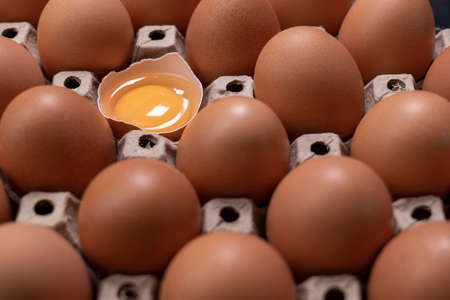 Happy Easter. Easter eggs. Chicken brown eggs closeup top view On the table. A carton crate of fresh brown eggs. Organic chicken eggs in an egg carton.の写真素材