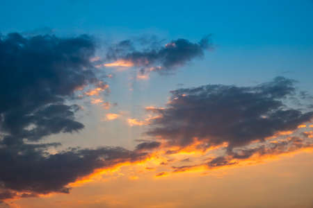 Beautiful sunset sky clouds with dramatic light,  dramatic sunset over a cloudy sky, evening outdoor background, Twilight sky with Colorful, Background of colorful sky concept sunset and sunrise.の写真素材