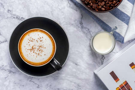 Coffee background, top view with copy space, Hot coffee with coffee filter holder, coffee beans the ground on marble table background. Coffee break at retro style coffee shop, top view for the menu.の写真素材