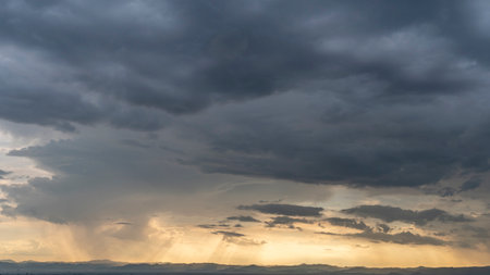 Dark storm clouds sky. Copy space below, a thunderstorm with the rain, nature Background, Dark ominous grey storm clouds. Dramatic sky ray.の写真素材